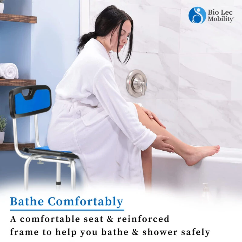 Woman in a bathrobe sitting on a shower chair next to a bathtub.