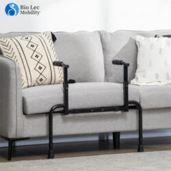 Adjustable sofa stand assist attached to a grey sofa with patterned cushions.