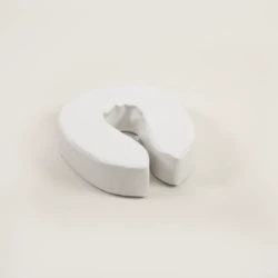 White padded raised toilet seat on a light background.