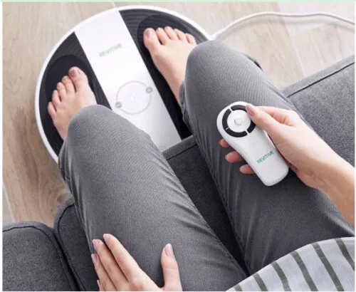 Person using Revitive foot massager with remote control.