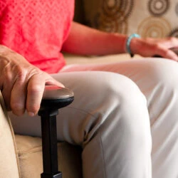 Person using the Stander EZ Stand N Go on a sofa.