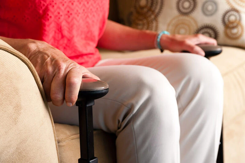 Person using the Stander EZ Stand N Go on a sofa.