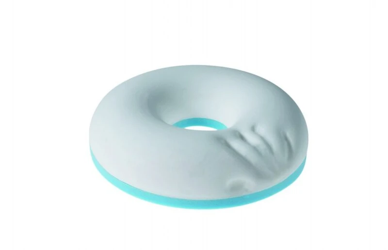 White and blue ring cushion with hand imprint.