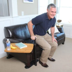 Man using a swivel table attached to a recliner.