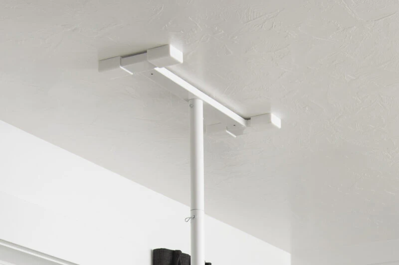 White security pole installed against a ceiling.