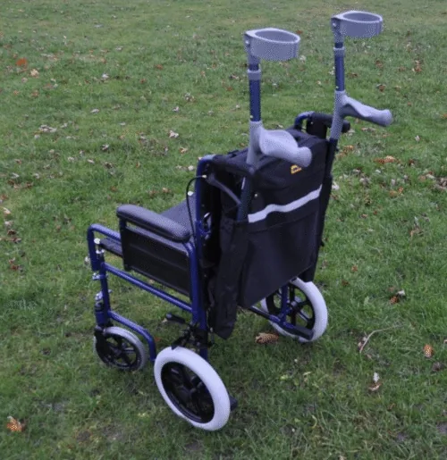 Mobility scooter bag with crutch holder attached to a wheelchair on grass.