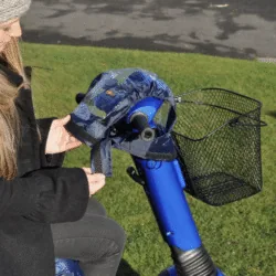 Person fitting a cover on a mobility scooter control panel.