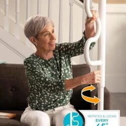 Woman using a white Stander Security Pole by a sofa.