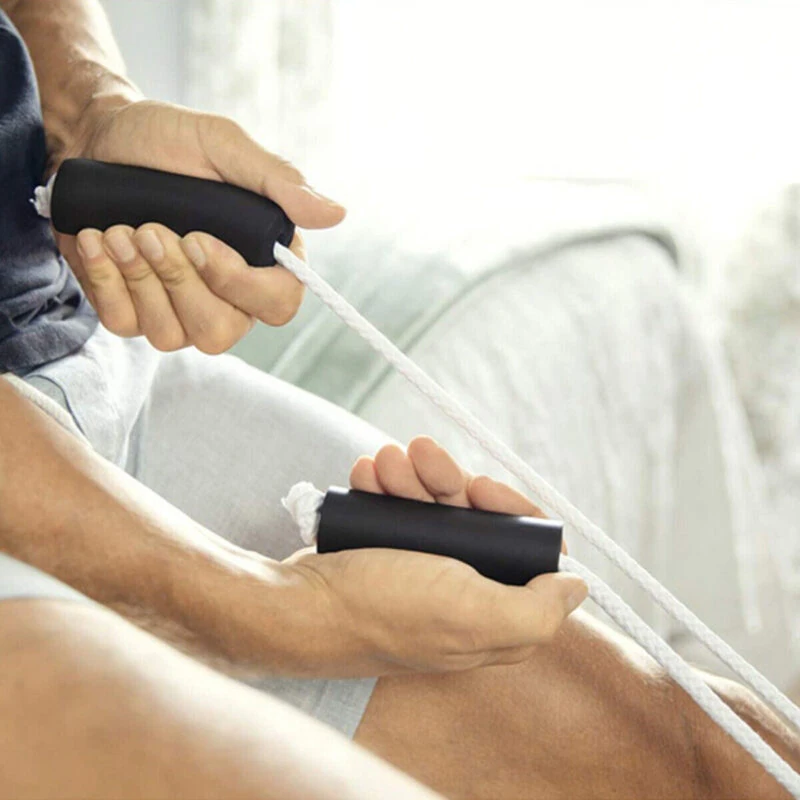 Person using a sock stocking aid with black handles and white rope.