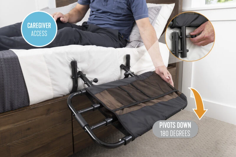 Bed rail with pouch attached to a bed, shown pivoting down for access.