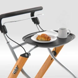 Indoor rollator with tray holding a croissant and coffee.