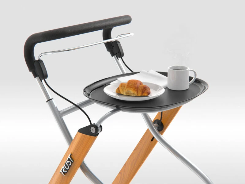 Indoor rollator with tray holding a croissant and coffee.