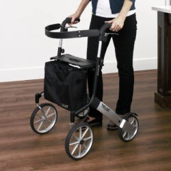 Person using a Trust Rollator with large wheels indoors.