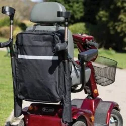 Black mobility scooter bag with walking stick holder attached to a red scooter.