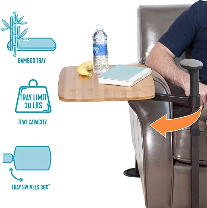 Swivel table attached to a recliner with a bamboo tray holding items.