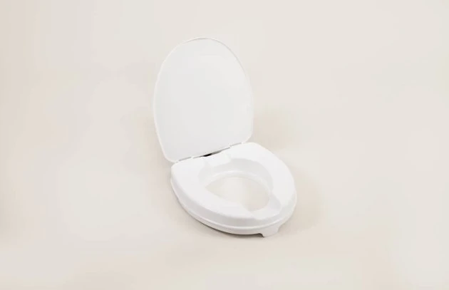 White toilet raiser seat with an open lid on a neutral background.