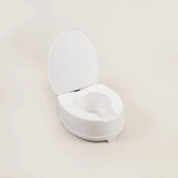 White toilet raiser seat with lid on a plain background.