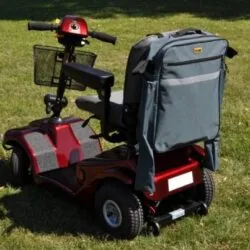 Mobility scooter with a grey bag attached to the back.