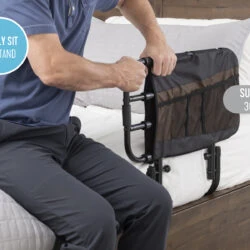 Person using the Stander EZ Adjust Bed Rail on a bed.