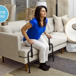 Person using the Stander EZ Stand N Go to stand up from a sofa.