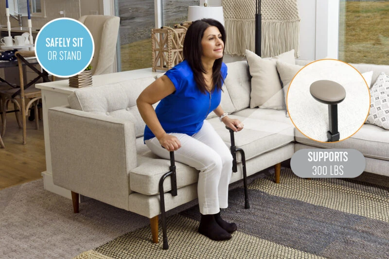 Person using the Stander EZ Stand N Go to stand up from a sofa.