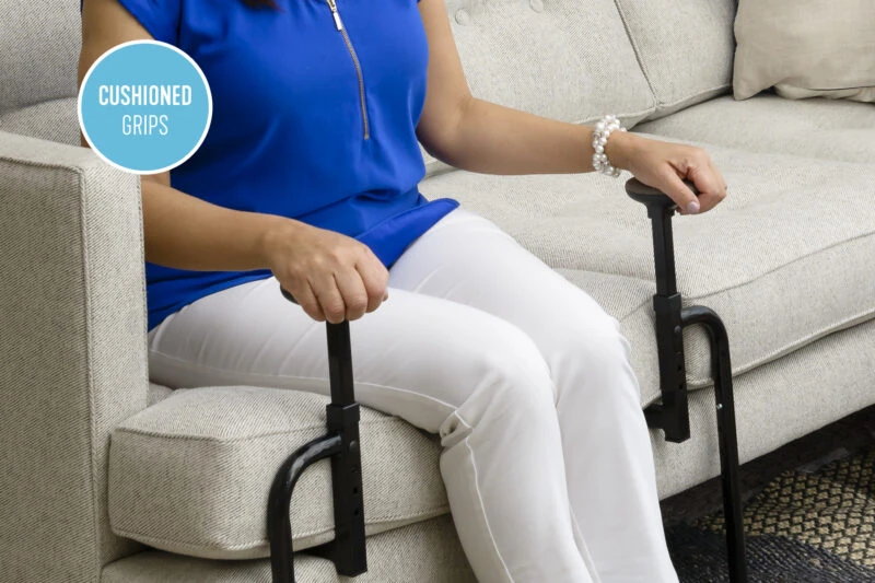 Person using EZ Stand N Go assist aid on a sofa.