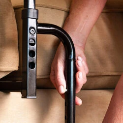 Close-up of a hand gripping the Stander EZ Stand N Go handle.