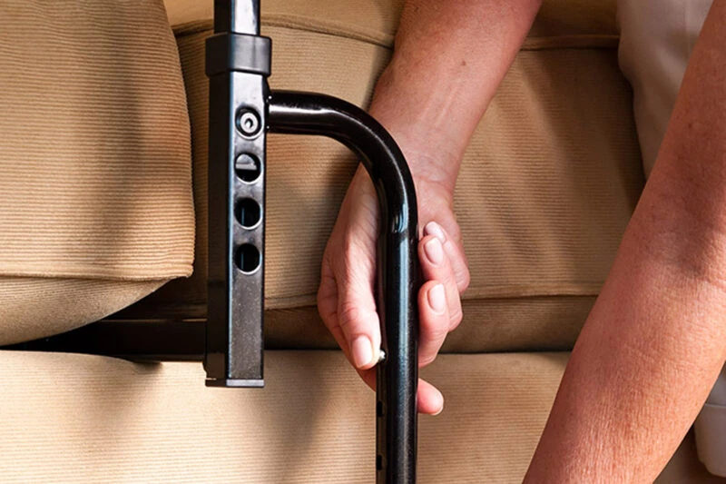 Close-up of a hand gripping the Stander EZ Stand N Go handle.