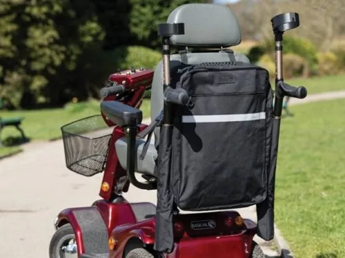 Black mobility scooter bag with double crutch holder on a red scooter.