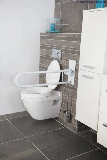 Folding bath rail mounted next to a toilet in a modern bathroom.