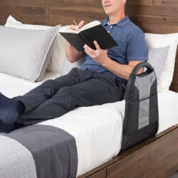 Person reading on bed with Stander Bedside Econorail attached.