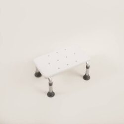 White bath step with adjustable legs and rubber feet.