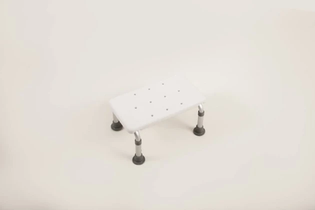 White bath step with adjustable legs and rubber feet.