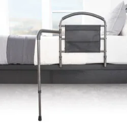 Mobility bed rail with swing-out arm attached to a bed.