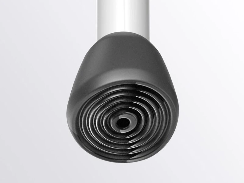 Close-up view of a black rubber foot on a bath stool leg.