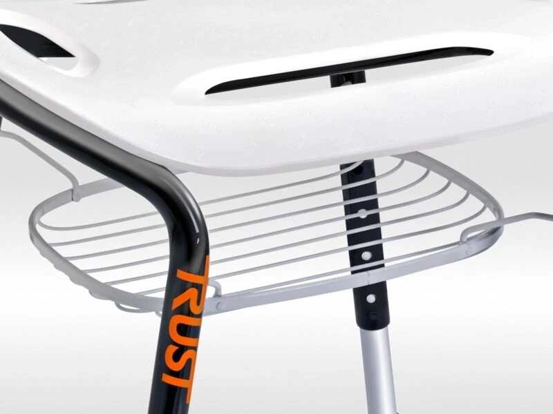 Close-up of white bath stool with black legs and metal wire basket.