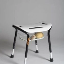 White bath stool with black legs and a metal wire basket underneath.