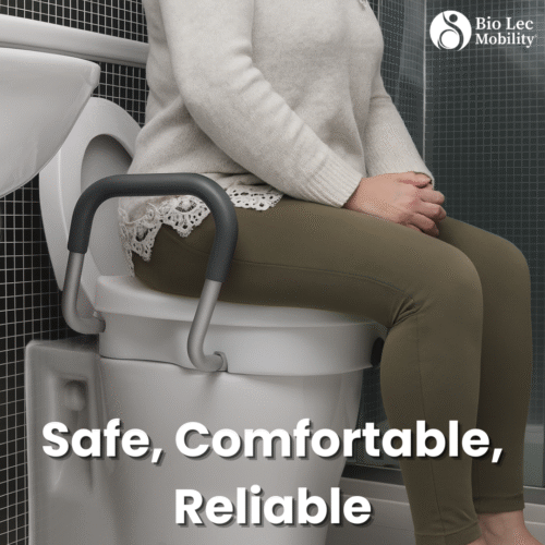 Person sitting on a toilet with a raised seat and handles.