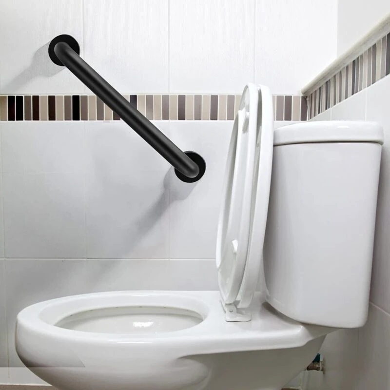 Black grab rail installed on a bathroom wall near a toilet.