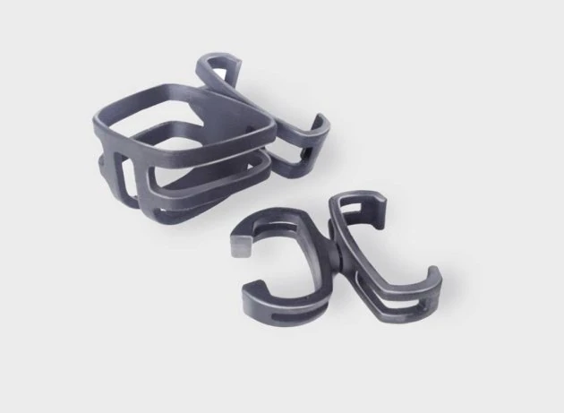 Two black crutch holders on a light background.