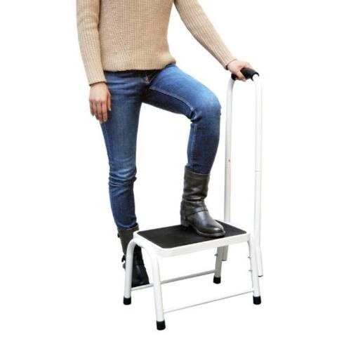 Person using a non-slip safety step with handrail.