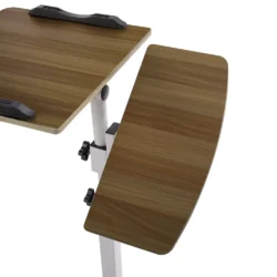 Overbed table with adjustable twin top in natural wood finish.