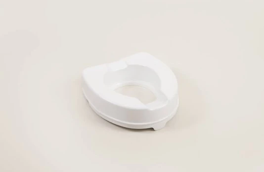 White raised toilet seat on a plain background.
