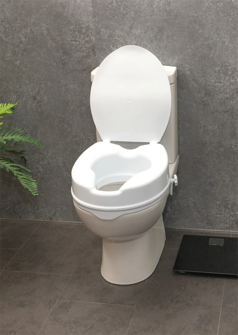 White elevated toilet seat with lid on a standard toilet.
