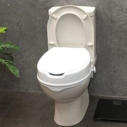 Elevated toilet seat with lid installed on a toilet.