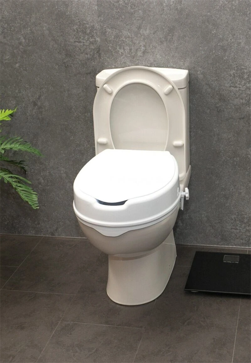 Elevated toilet seat with lid installed on a toilet.