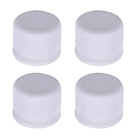 Four white rubber caps arranged in a square pattern.