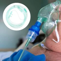 Close-up of a nasal cannula and oxygen mask on a patient.