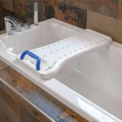 White bath board with blue handle placed over a bathtub.