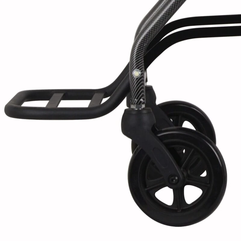 Close-up of a wheelchair's footrest and front wheels.